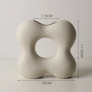 Beige abstract sculpture with dimensions indicated on a light gray background