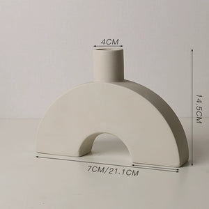 Ceramic vase with measurements on a plain background