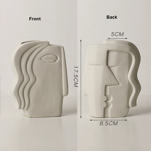 Ceramic vase with face design shown from front and back, with measurements indicated.
