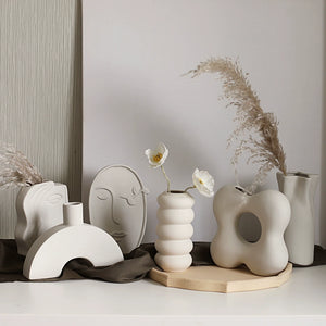 Collection of modern ceramic vases with unique designs on a neutral background