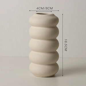 Beige ribbed vase with measurements on a light gray background